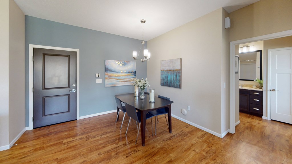 a dining room with a table and chairs at Skye at Arbor Lakes, Maple Grove, MN