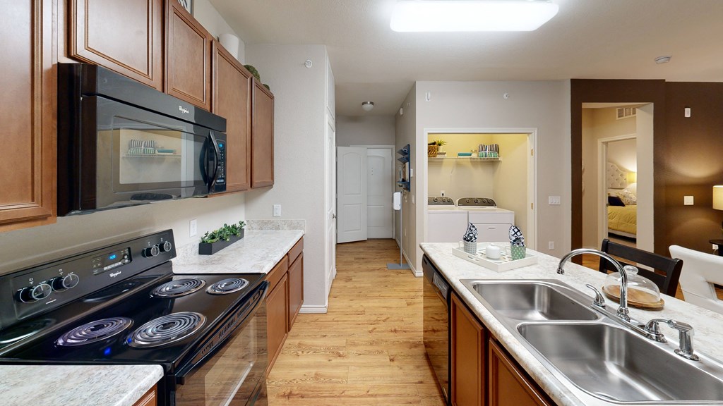 a kitchen with wood cabinets and white countertops