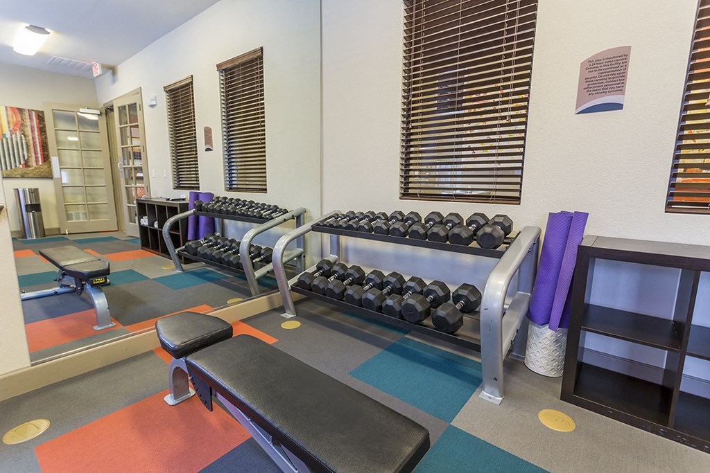 a fitness center with weights and other exercise equipment