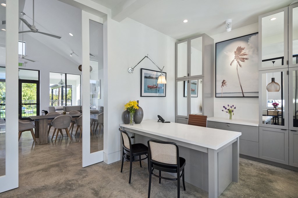 Office in resident clubhouse with a large white desk and two black chairs at Odyssey, Florida