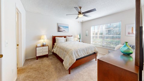 a bedroom with a bed and a ceiling fan  at Somerset Apartments, Largo, Florida