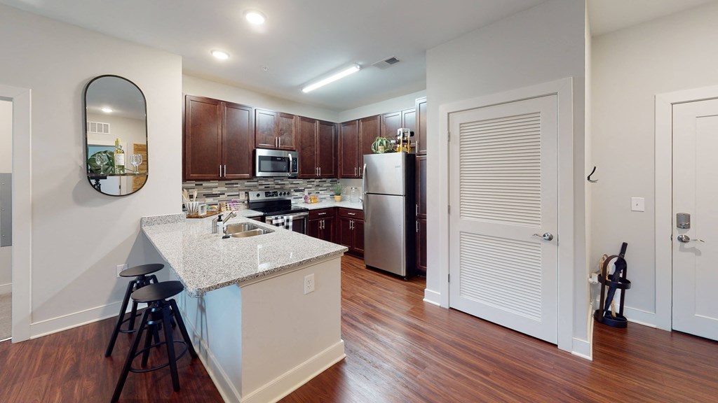 a kitchen with an island and stools