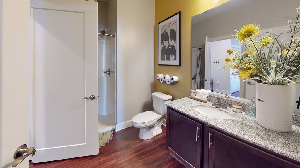 a bathroom with a toilet sink and shower