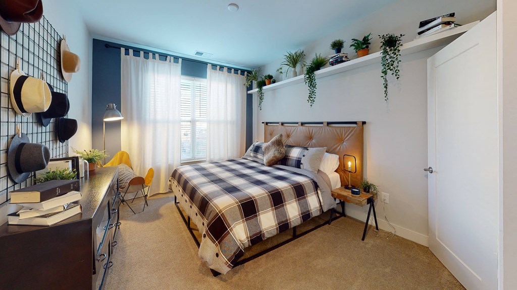 a bedroom with a bed and a desk