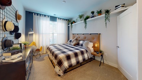 a bedroom with a bed and a desk at The Bend Arbordale, Williamsburg, VA