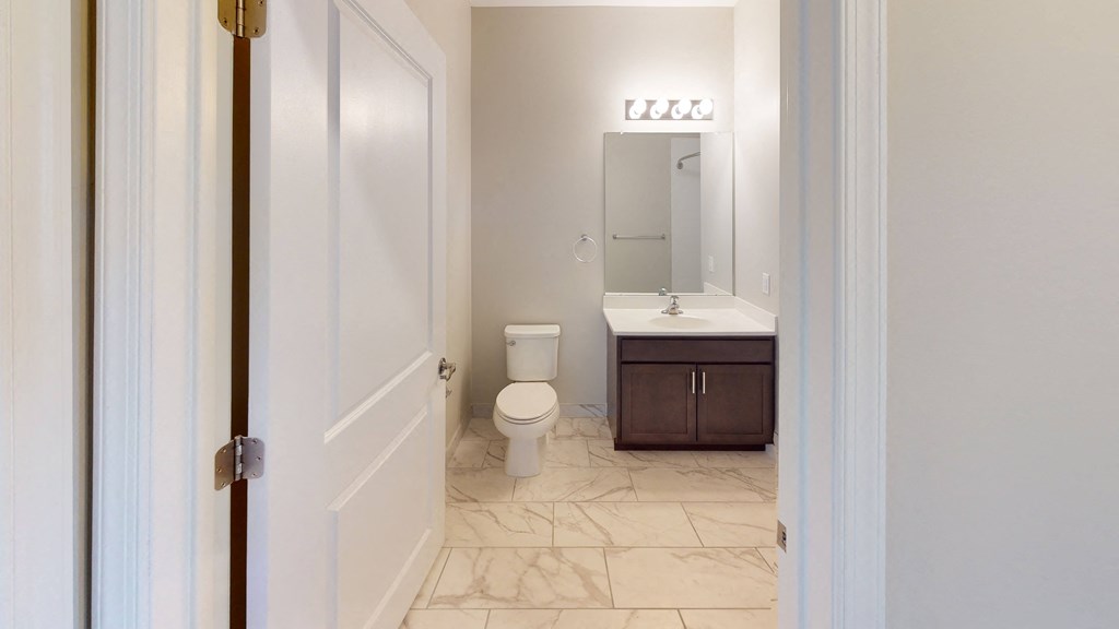 a bathroom with a toilet sink and mirror at The Landing Apartment , New Jersey