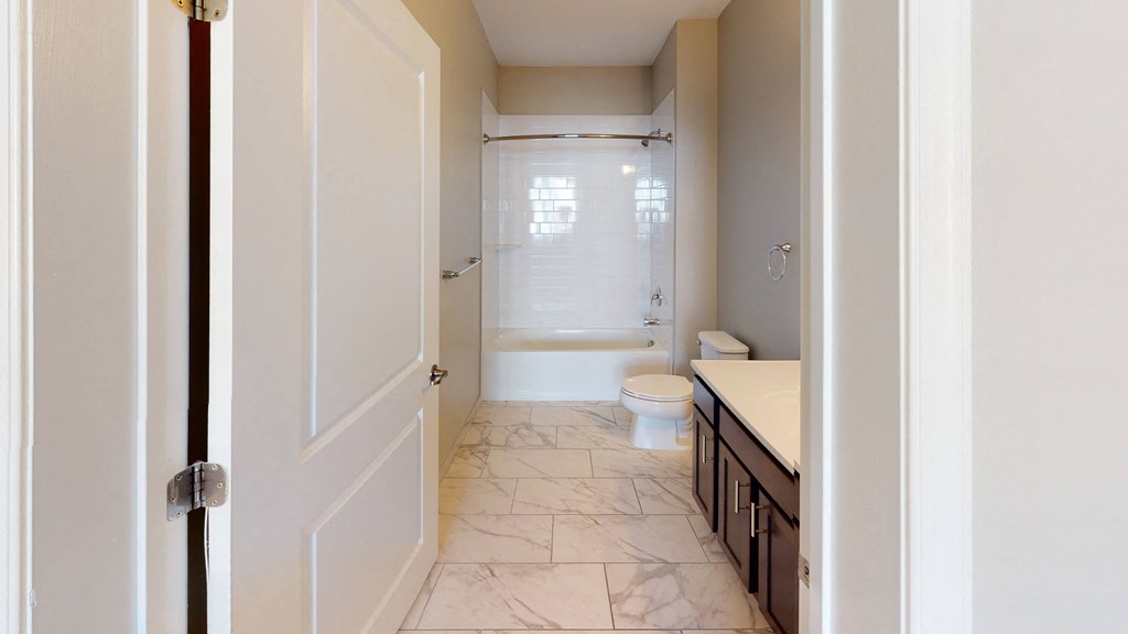 a bathroom with a toilet and a sink at The Landing Apartments, Hazlet