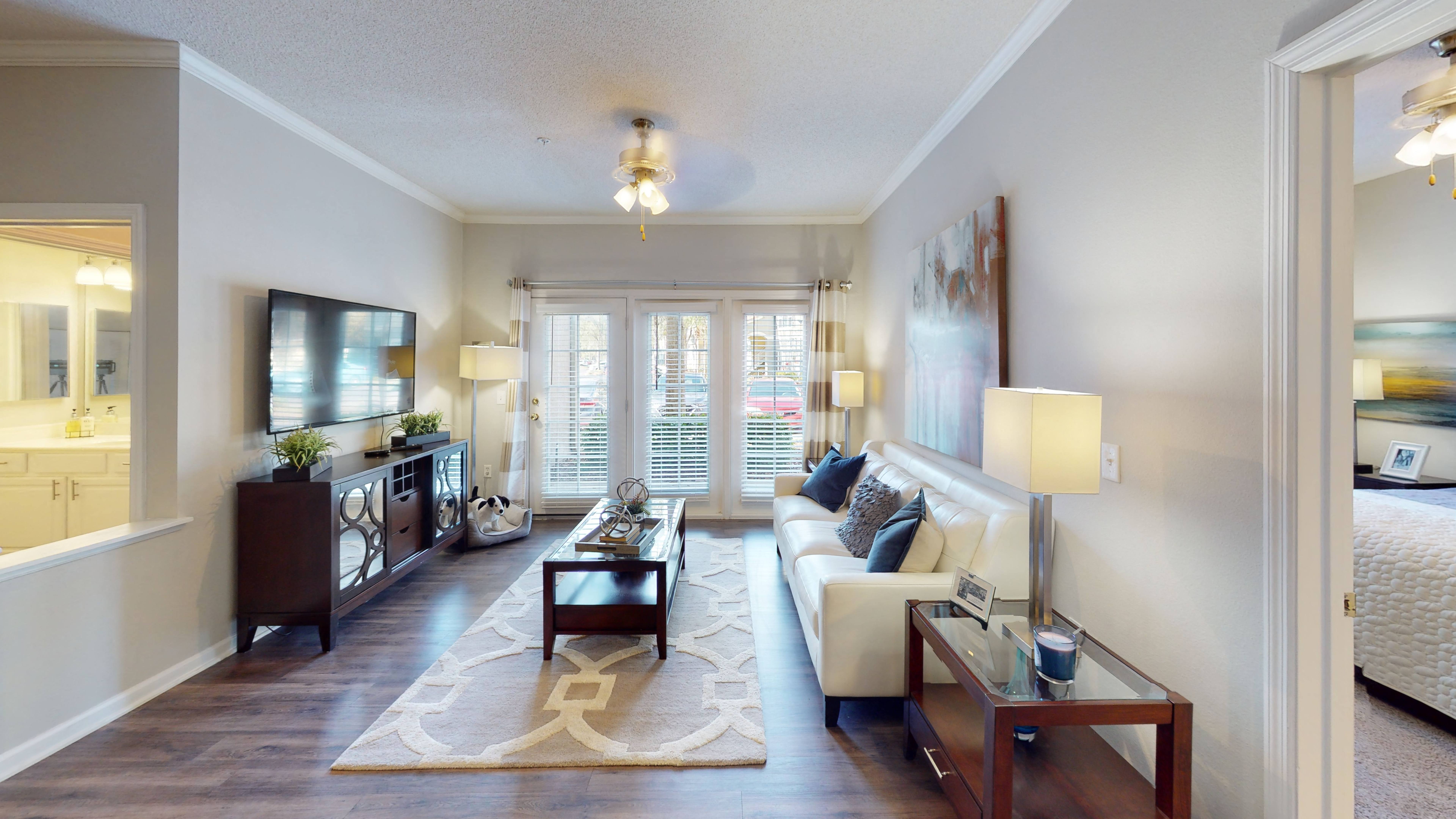 a living room filled with furniture and a large window
