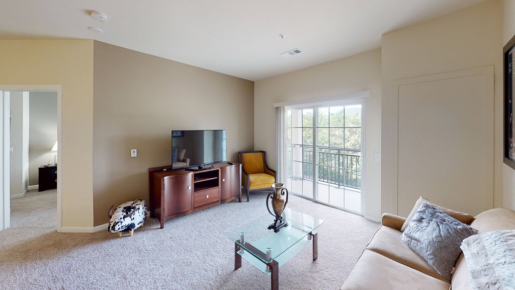 a living room with a couch and a tv at The Reserve at Riverdale, New Jersey