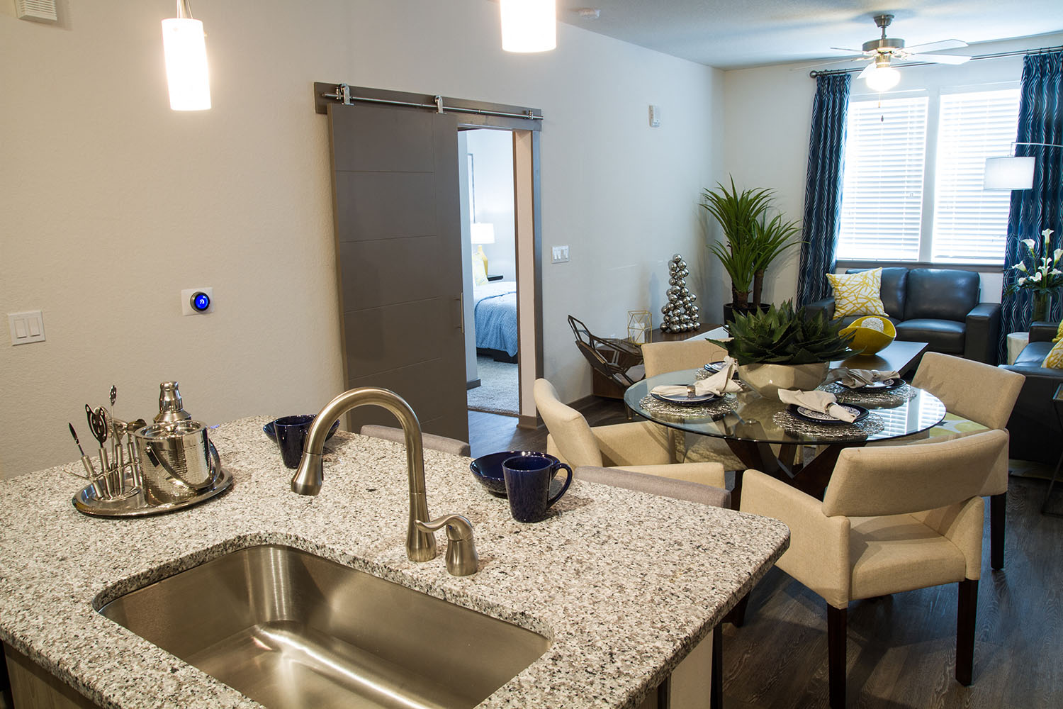 a kitchen and living room with a sink and a table