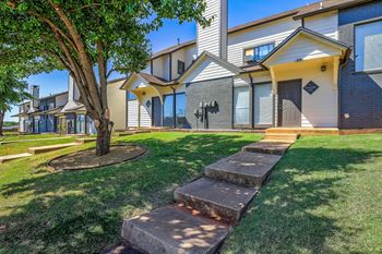 a group of houses with stairs in the grass at Diamond Ridge Townhomes, Oklahoma City, OK