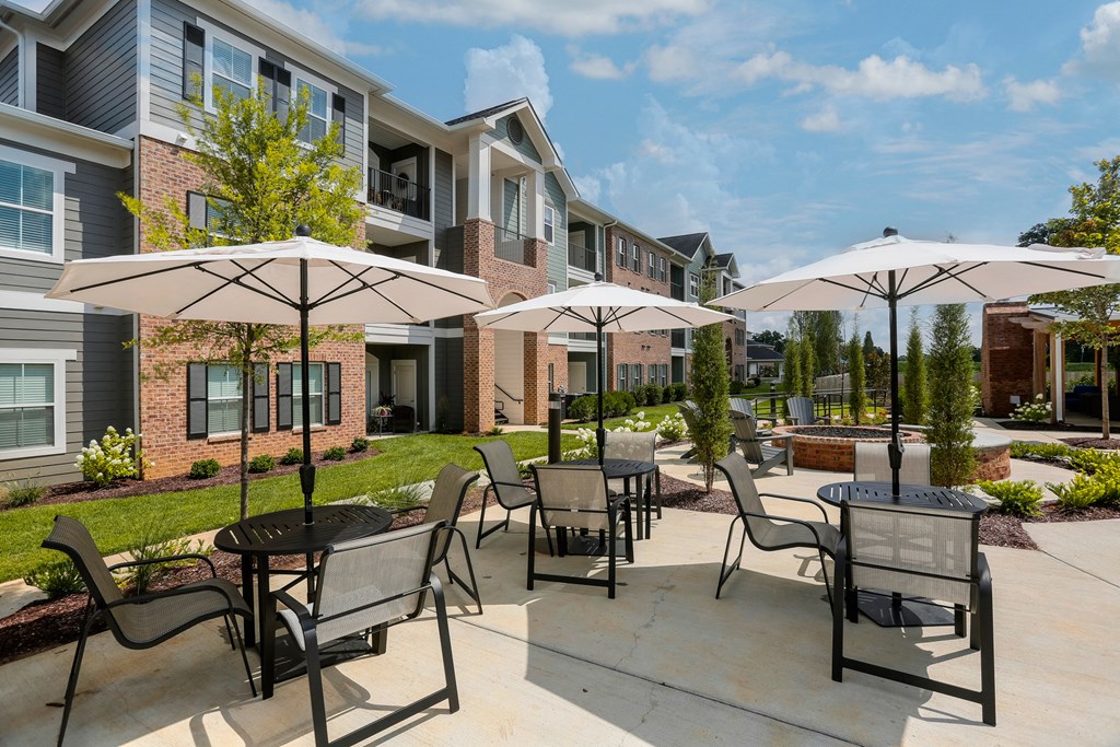 our apartments feature a patio with tables and chairs and umbrellas at Annandale Apartment Homes, Murfreesboro, Tennessee
