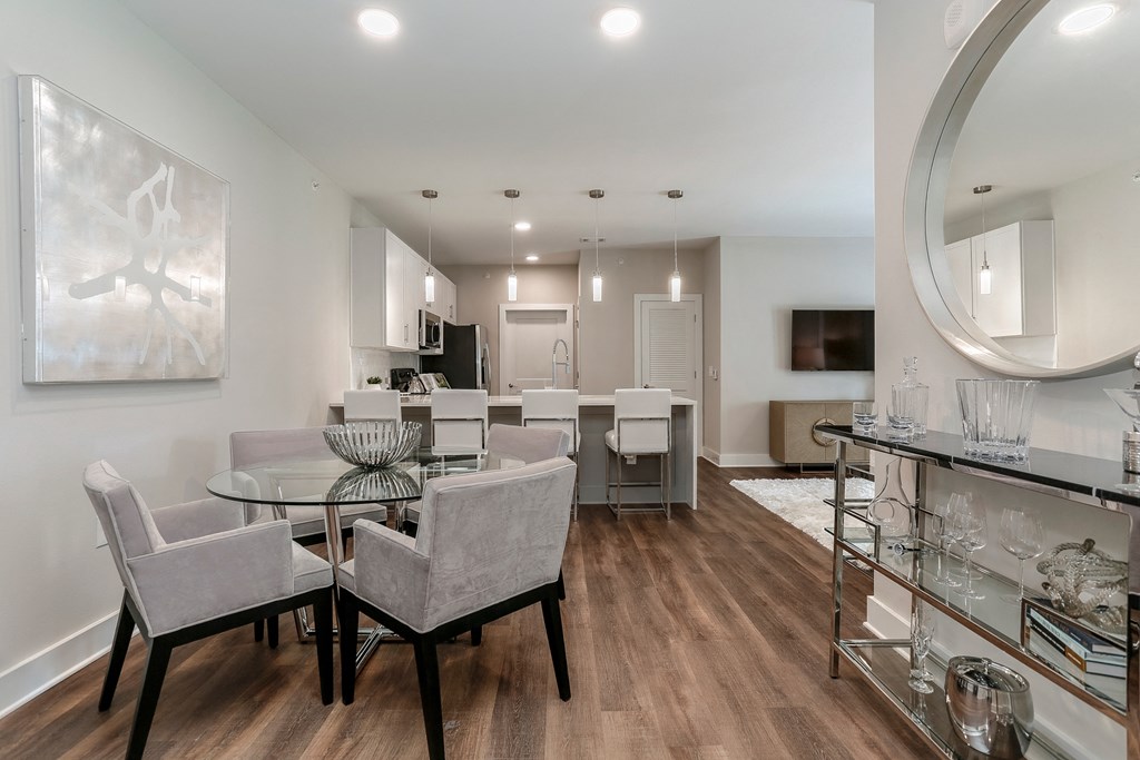 a living room and dining room with a glass table and chairs at Annandale Apartment Homes, Murfreesboro