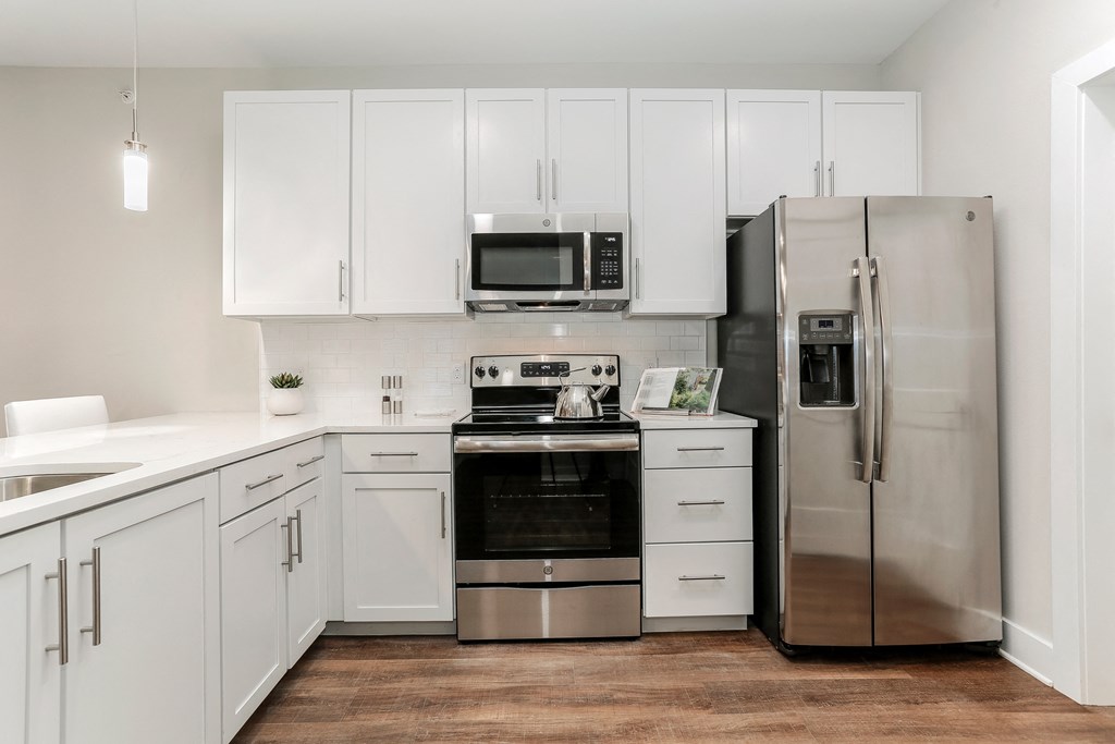 a white kitchen with stainless steel appliances and white cabinets at Annandale Apartment Homes, Murfreesboro, TN