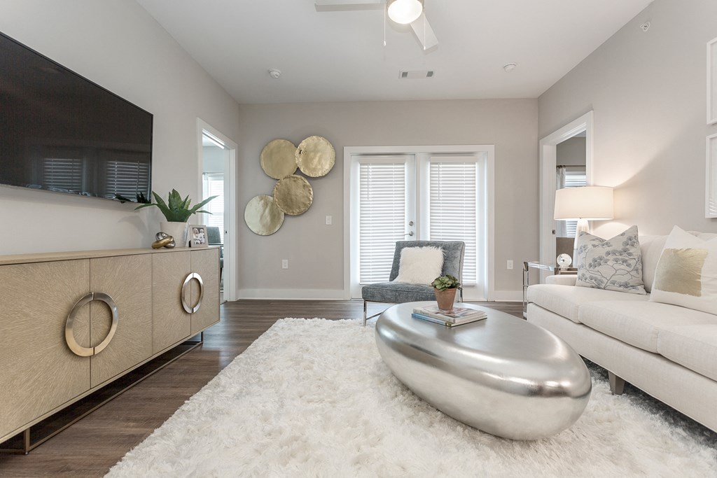 a living room with a white rug and a white couch at Annandale Apartment Homes, Tennessee 37128