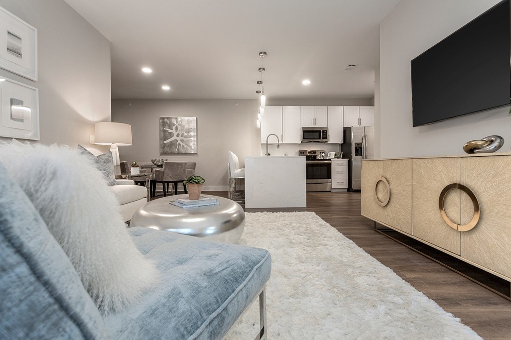 a living room with a couch and a chair and a kitchen at Annandale Apartment Homes, Tennessee
