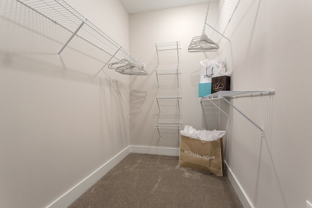 a walk in closet with a bag of groceries on the floor and a white wall at Annandale Apartment Homes, Murfreesboro, TN, 37128