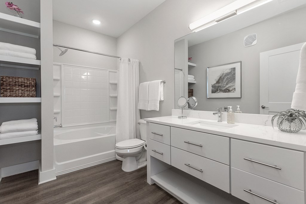 a bathroom with a large mirror and a toilet and a shower at Annandale Apartment Homes, Murfreesboro