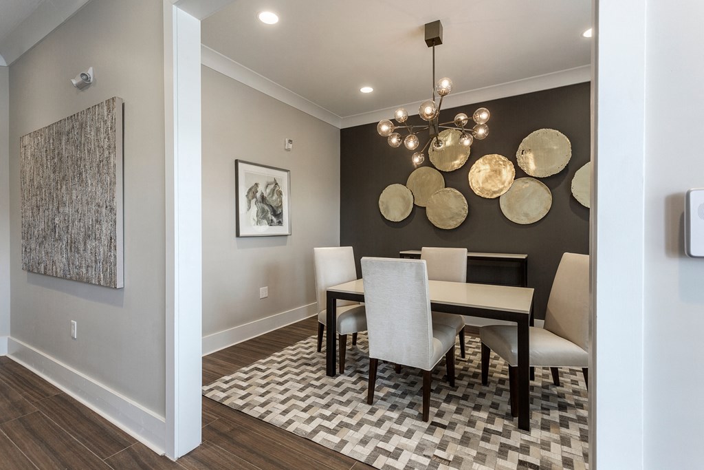 a dining room with a table and chairs and a chandelier at Annandale Apartment Homes, Murfreesboro, TN