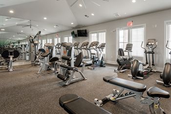 view of fitness center with cardio machines and weights
