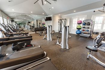 view of fitness center with cardio machines and weights