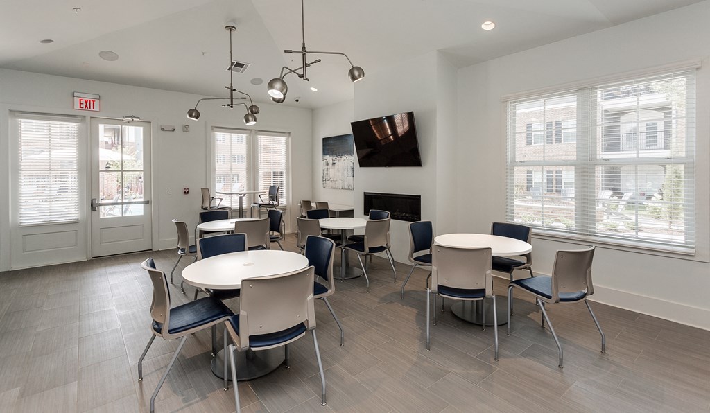 a dining room with tables and chairs and a fireplace at Annandale Apartment Homes, Tennessee 37128