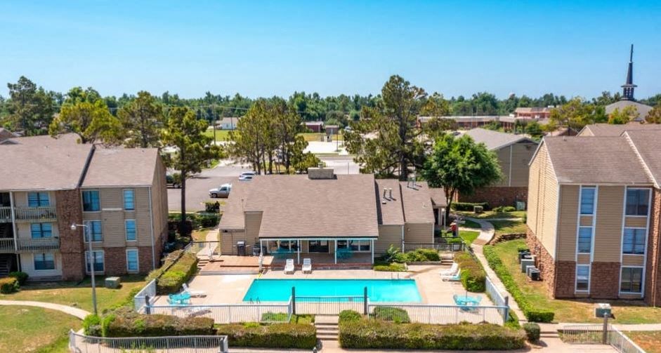 an aerial view of an apartment complex with a swimming pool