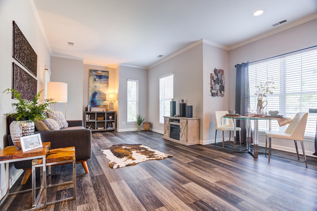Expansive living room with wood style flooring at Dwell at Naperville, Naperville, IL