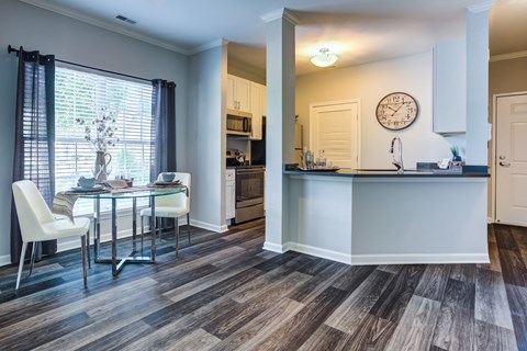 a kitchen and dining room with a table and chairs and a counter