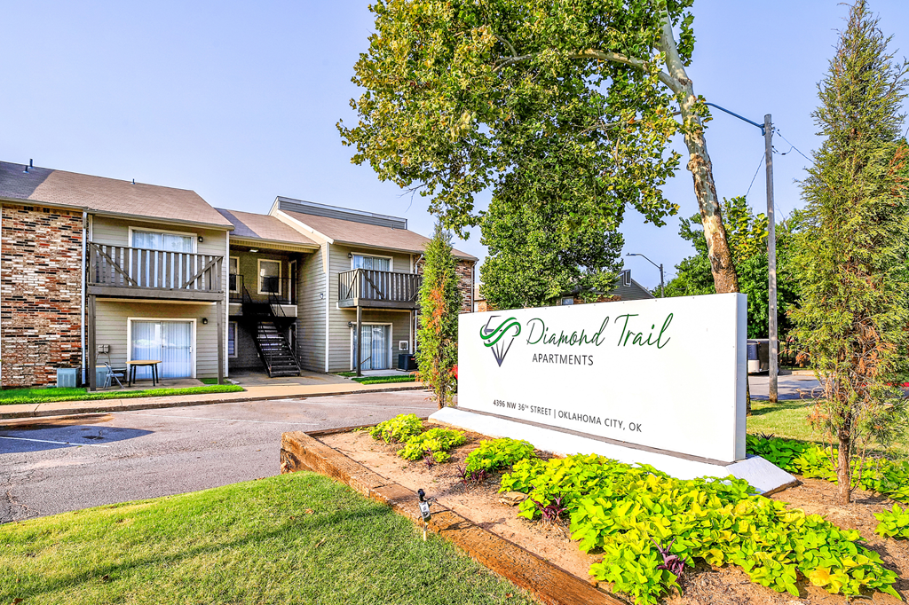 our sign is in front of our building with trees and grass at Diamond  Trail Apartments, Oklahoma City, OK, 73112