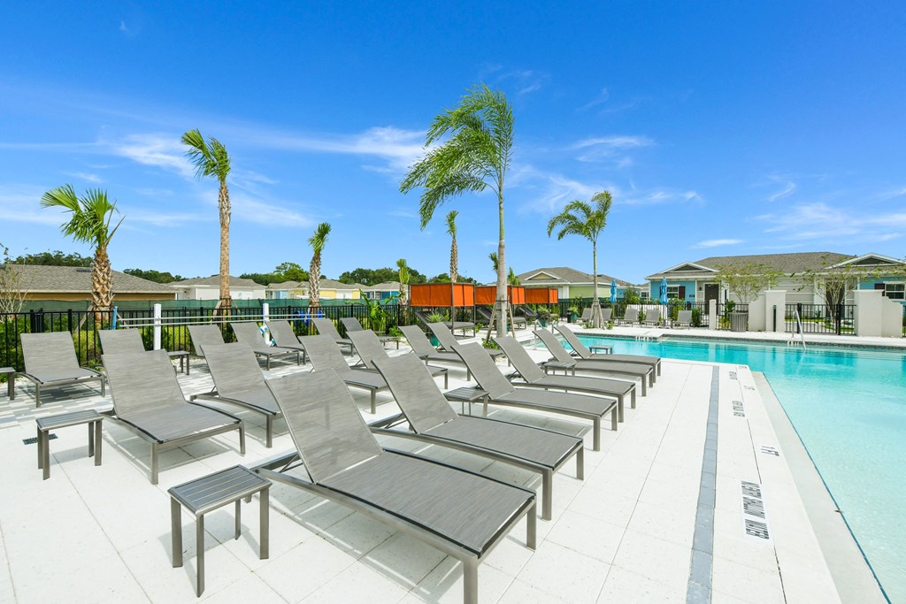 Sun deck next to a resort style swimming pool