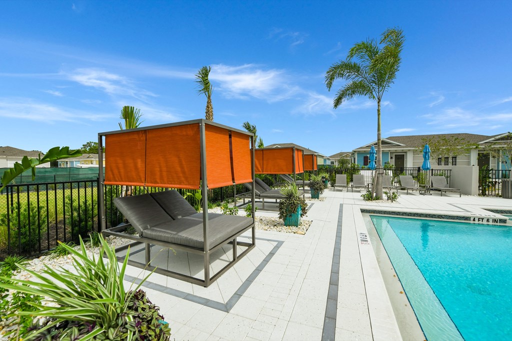 Sun deck next to a resort style swimming pool