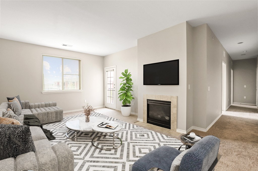 a living room with a fireplace and a tv