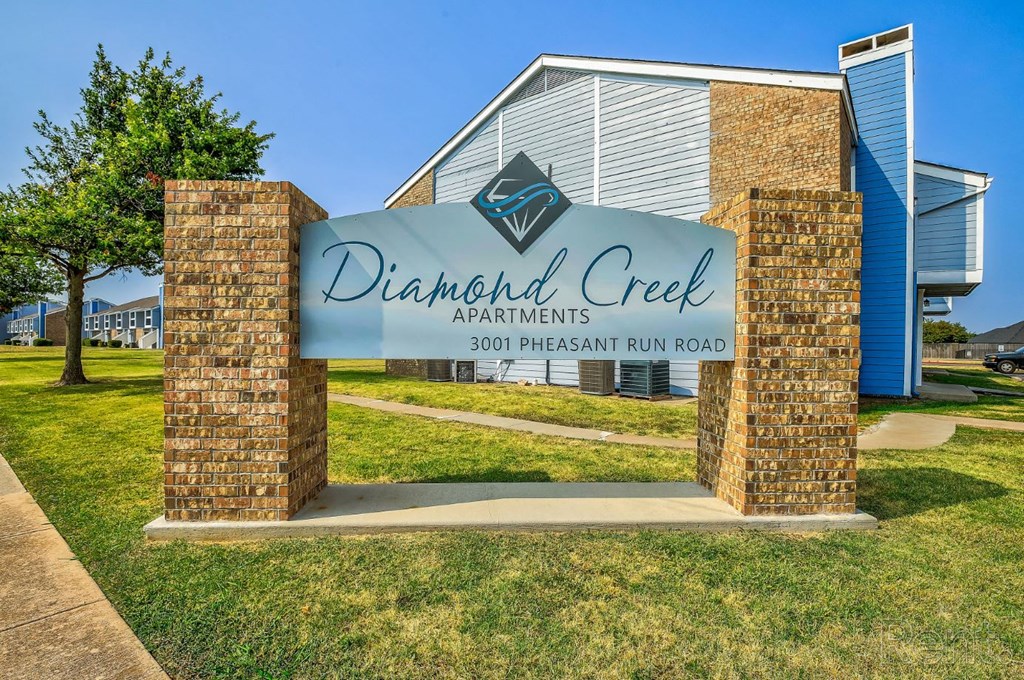 a sign with a building in the background