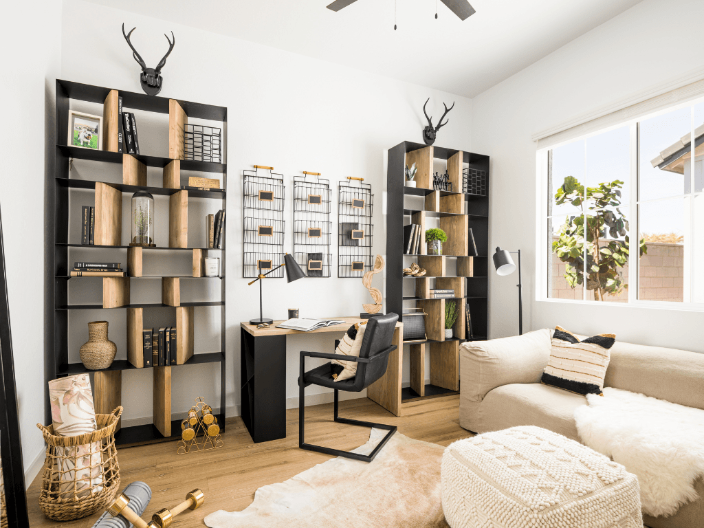 a living room with a couch and a desk in a home office
