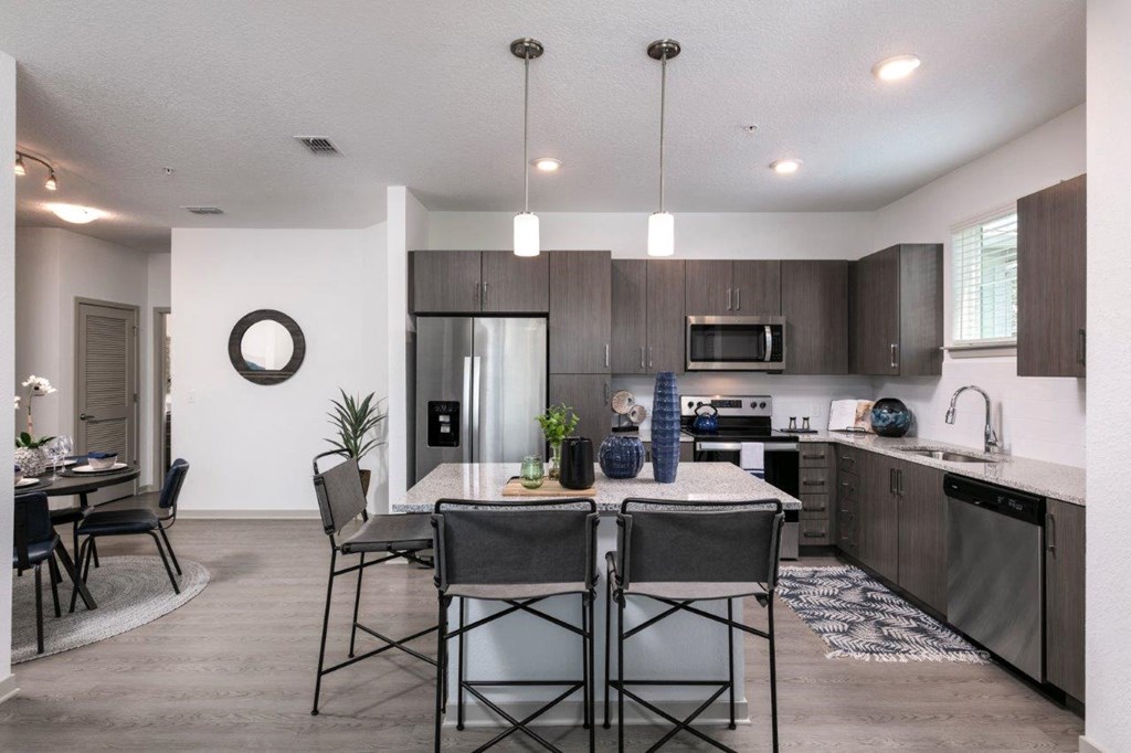 an open kitchen and dining room with a table and chairs at Enclave at 3230 Apartments, South Daytona