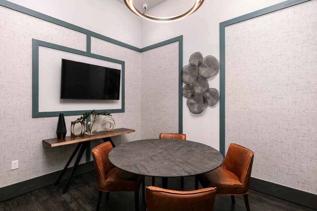 A modern dining room with a round table and chairs at Enclave at 3230 Apartments, South Daytona, FL, 32119