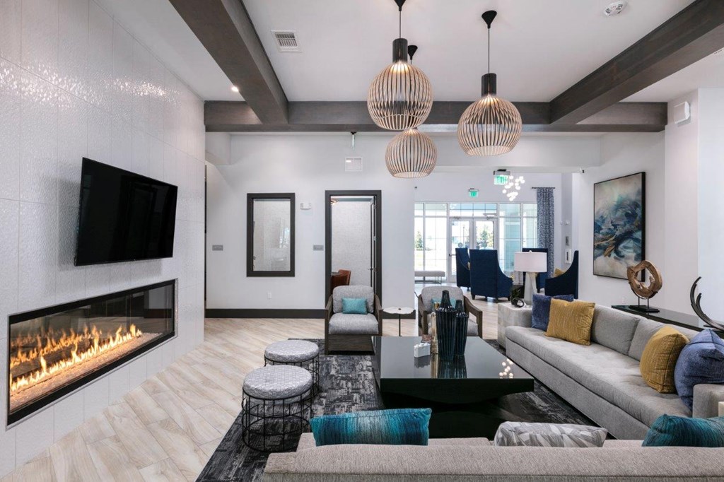 the living room has a fireplace and a large couch at Enclave at 3230 Apartments, Florida, 32119