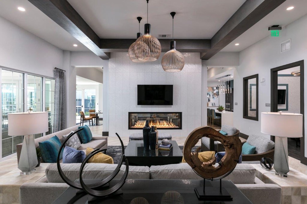 a living room with a fireplace and couches at Enclave at 3230 Apartments, Florida, 32119
