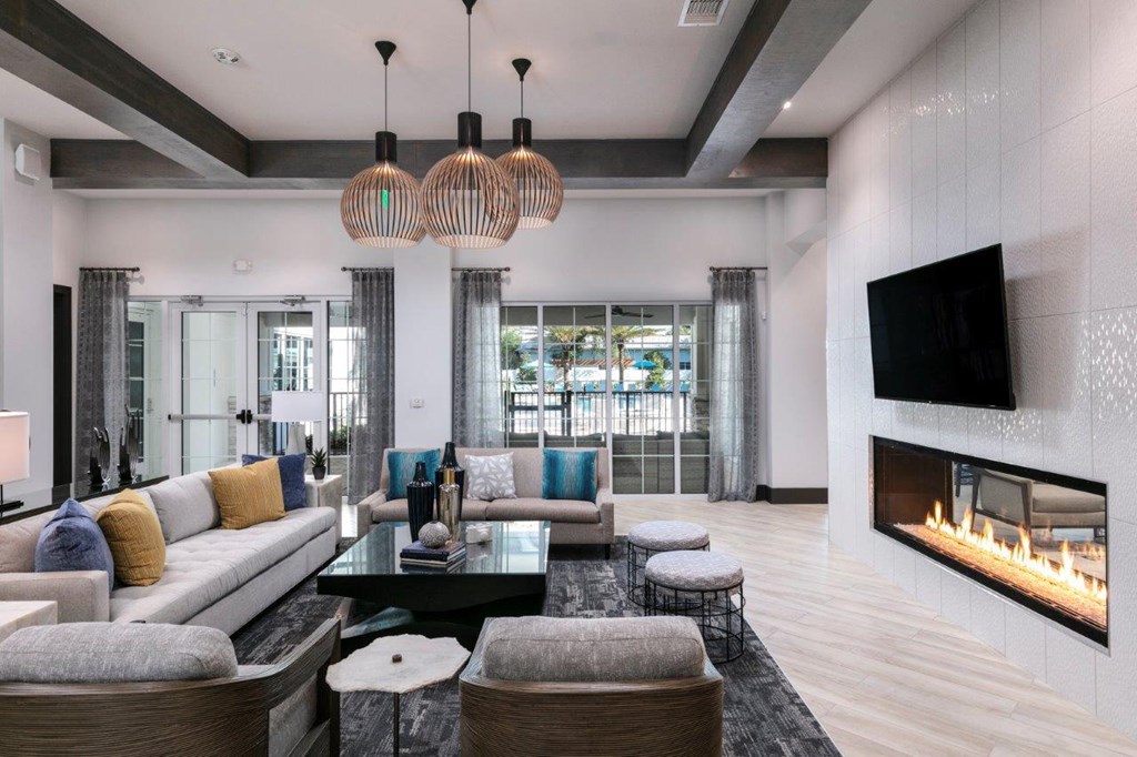 a living room with couches and a television and a fireplace at Enclave at 3230 Apartments, South Daytona, FL, 32119