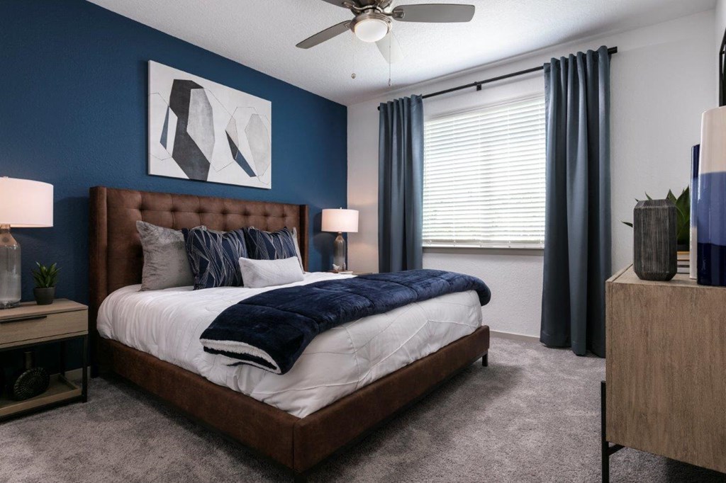A bedroom with a large bed and a ceiling fan at Enclave at 3230 Apartments, South Daytona, Florida