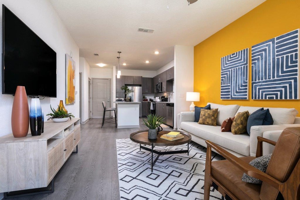 a living room with a couch and a table at Enclave at 3230 Apartments, South Daytona, FL, 32119
