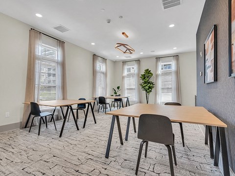A conference room with a long table and chairs.