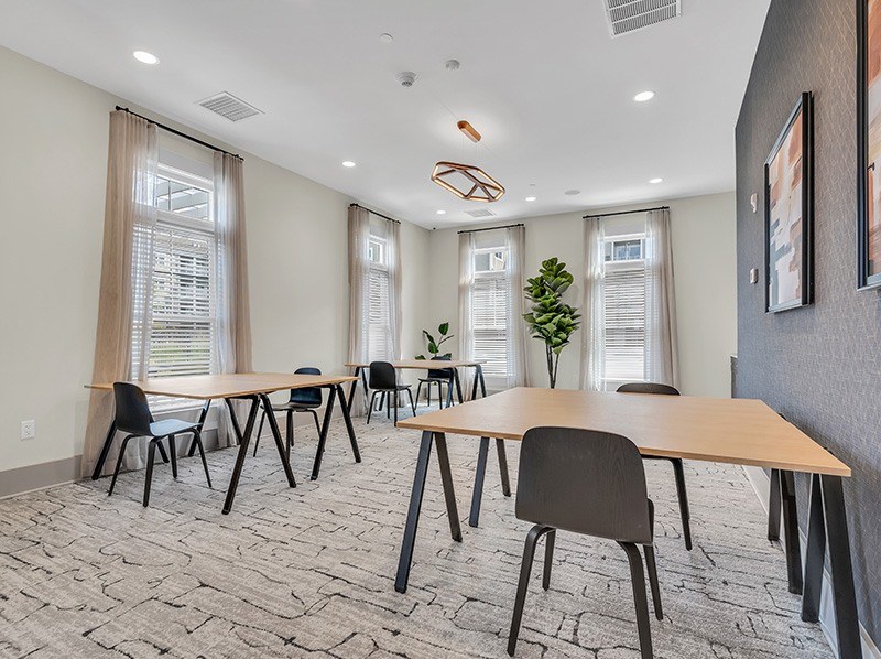 A conference room with a long table and chairs.