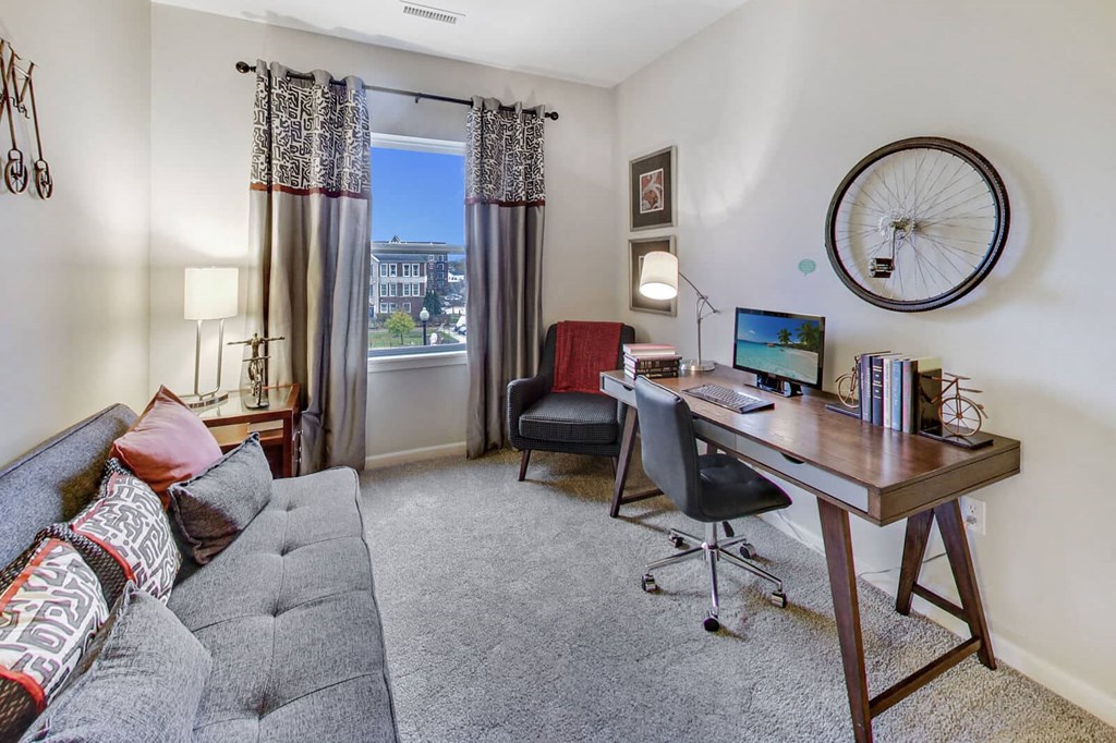 a living room with a couch and a desk with a computer at Wheaton 121, Wheaton, 60187