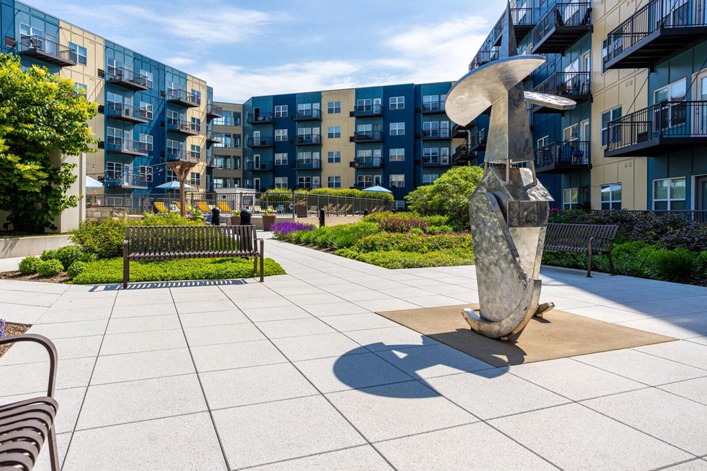 a sculpture of a dolphin in front of an apartment building at Wheaton 121, Illinois, 60187