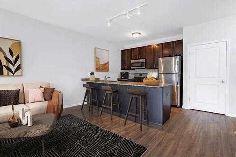 A kitchen with dark wood cabinets and a white door.