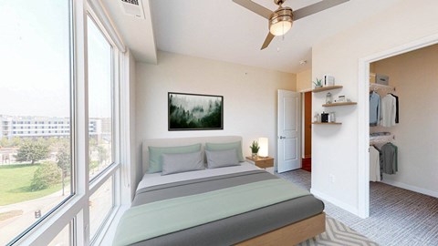 A bedroom with a large bed and a ceiling fan. at The Arlow on Kellogg, Minnesota