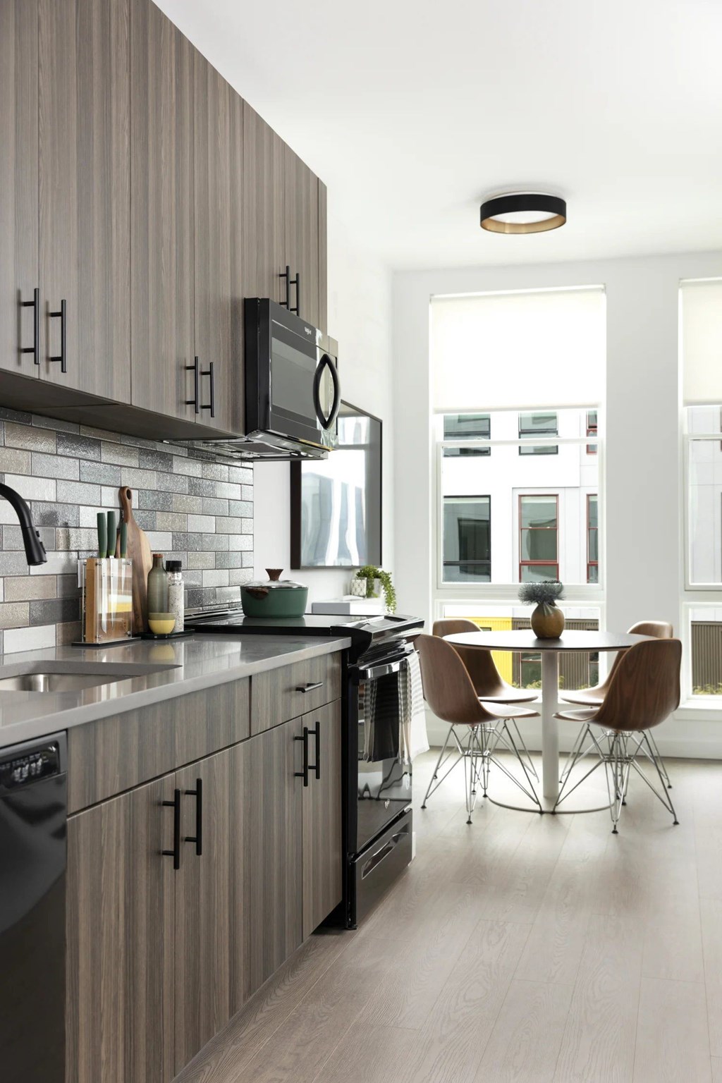 A modern kitchen with a dining table and chairs.