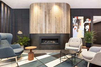 A modern living room with a fireplace and comfortable seating.